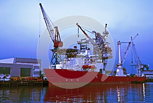 Freighter in Rotterdam harbor at night in Holland