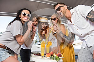 Freinds drinking cocktails on yacht