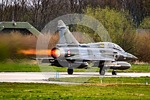 French Air Force Dassault Mirage 2000 fighter jet plane afterburner take-off from Leeuwarden Airbase. April 11, 2019