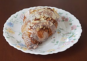 French Almond Croissant On Flowered Plate