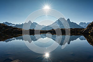 French Alps landscape of Lac des Cheserys with Mont Blanc massif and trail runner reflection at France