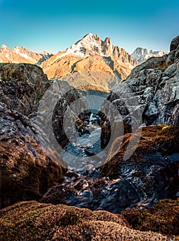 French alps mountain with stream flowing in rocky valley at Lac Blanc