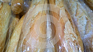 French baguette in package. Baked bread. Hot fresh wheat long loaf. Breadmaking and baked goods concept. Natural bakery products.
