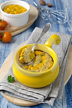 French baked cheese souffle with carrots and dill in white ramekin