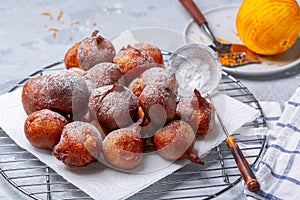 French beignets with powdered sugar and orange zest