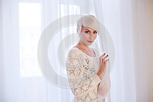 French blonde in a white room