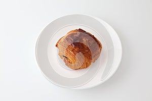 French bread pain au chocolat chocolate croissant on plate on white background