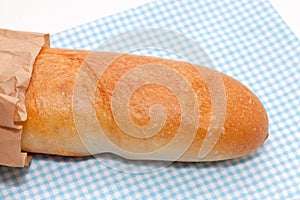 French bread with paper bag on white