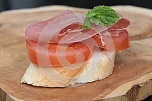 French bread topped with tomato and ham