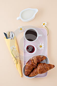 French breakfast: black coffee, milk and a croissant with jam se