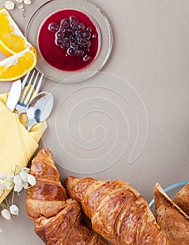 French breakfast - croissants, toast and oranges, on a light brown background with space for text