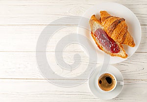 French breakfast. Delicious, fresh croissants with jam and a cup of coffee.