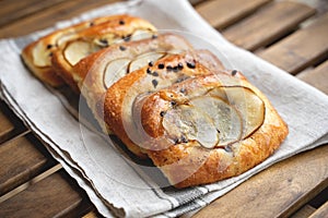 French brioche bun with pear on wooden