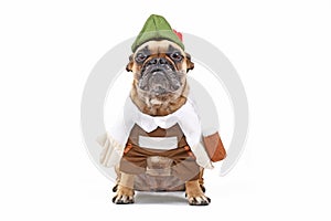French Bulldog dog dressed up with funny traditional Bavarian `Oktoberfest` costume with Lederhosen pants, tirol hat and beer