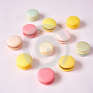 French cake macaron. Set of cute sweets on pastel pink background. almond cookies, pastel colors, top view