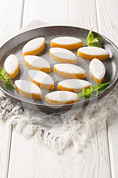 French candy Calissons consisting of pale yellow homogeneous paste of candied fruit melons and oranges and ground almonds topped