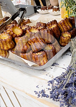 French canele dessert on wooden counter with lavender