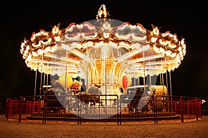 Carousel (Merry-Go-Round) illuminated at night photo
