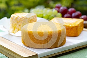 French cheeses collection, Riche de Saveurs, Langres and Le peche des bons peres cheeses served on white marble plate outdoor in