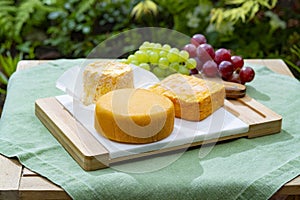 French cheeses collection, Riche de Saveurs, Langres and Le peche des bons peres cheeses served on white marble plate outdoor in