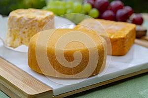 French cheeses collection, Riche de Saveurs, Langres and Le peche des bons peres cheeses served on white marble plate outdoor in