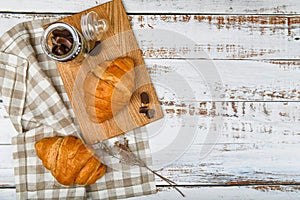 French chocolate croissants top view. the beginning of the morning. Fresh french croissant. Coffee cup and fresh baked croissants