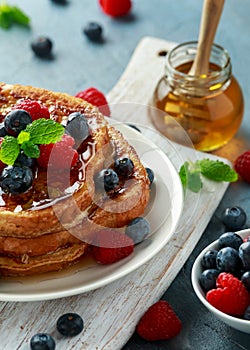 French cinnamon toast with blueberries, raspberries, maple syrup and coffee. morning breakfast