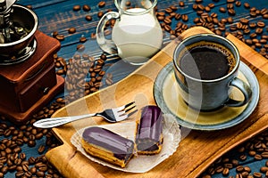 French coffee with cream and Eclair and coffee beans