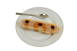 French coffee eclair served on a plate isolated on white