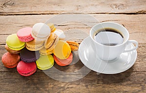 French colorful macarons with cup of coffee casual