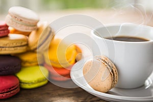 French colorful macarons with cup of coffee casual