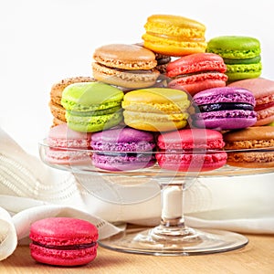 French colorful macarons in a glass cake stand