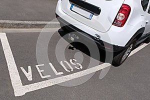 French concept of incivility with a car parked on an area reserved for bicycles