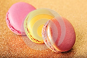 french cookies macaron on golden backgrouns photo