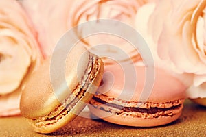 french cookies macaron on golden backgrouns photo