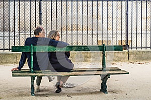 French couple sitting on a bench
