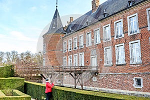 French courtyard with female tourist taking a photo with her cell phone