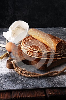 French crepes or pancakes with ingredient on grey background.