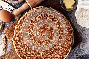 French crepes or pancakes with ingredient on grey background.