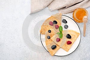 French Crepes With Summer Berries And Honey On Plate