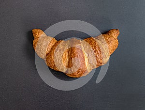 French croissant on grey slate background. Idea minimal concept