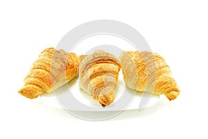 French croissants on a white plate on a white background.