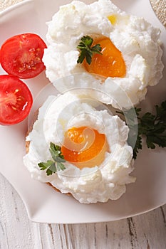 French cuisine: baked eggs Orsini and tomato closeup. vertical t