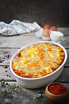 French cuisine. Vegetable pumpkin clafoutis in ceramic bakeware, eggs and cream