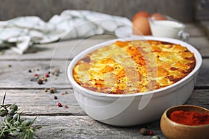 French cuisine. Vegetable pumpkin clafoutis in ceramic bakeware, smoked paprika dressing, eggs and cream