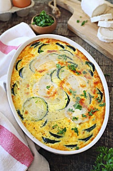 French cuisine. Vegetable zucchini clafoutis with goat cheese in ceramic bakeware