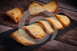 French delicacy pastry tuile with almond on wood background