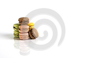 French dessert for coffee. Group of multicolored macarons on white background