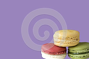 French Dessert Macaron on Purple Background with Copy space