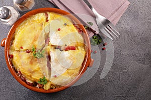 french dish with potato, bacon and cheese